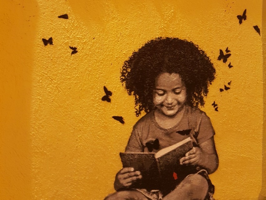 graffiti child reading book street art PNG high quality